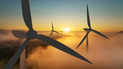 Wind turbine silhouette at sunrise, wind energy