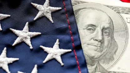 American flag draped over a one hundred dollar bill, symbolizing patriotism and wealth