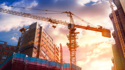 Government building undergoing construction with crane