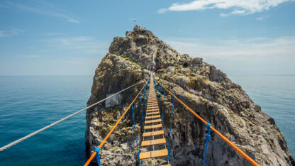 suspension bridge stretches over the ocean