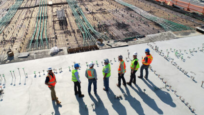 Workers standing at a building construction site