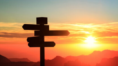 Silhouette of a signpost in a colorful sunset