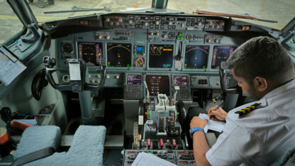 Co-pilot making navigating preparations before a flight